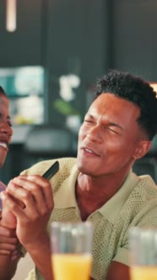 Excited Man Singing and Dancing with Phone Indoors