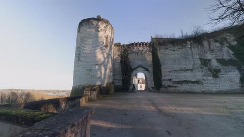 Majestic Saint-Aignan Castle with Ancient Stone Wall and Archway at Dawn