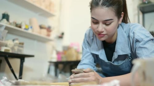 Woman Working with Clay in Pottery Studio