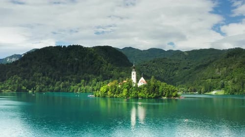 Idyllic scenery of Bled Island with its church reflecting in turquoise water
