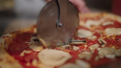 Cutting a Pizza with Pizza Cutter, Close Up