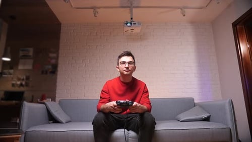 Man Playing Video Games on Couch in Living Room