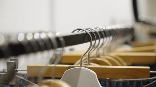 Rack of clothes on wooden hangers indoors