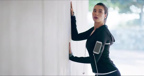 Young Woman Stretching Against Concrete Wall Outdoors