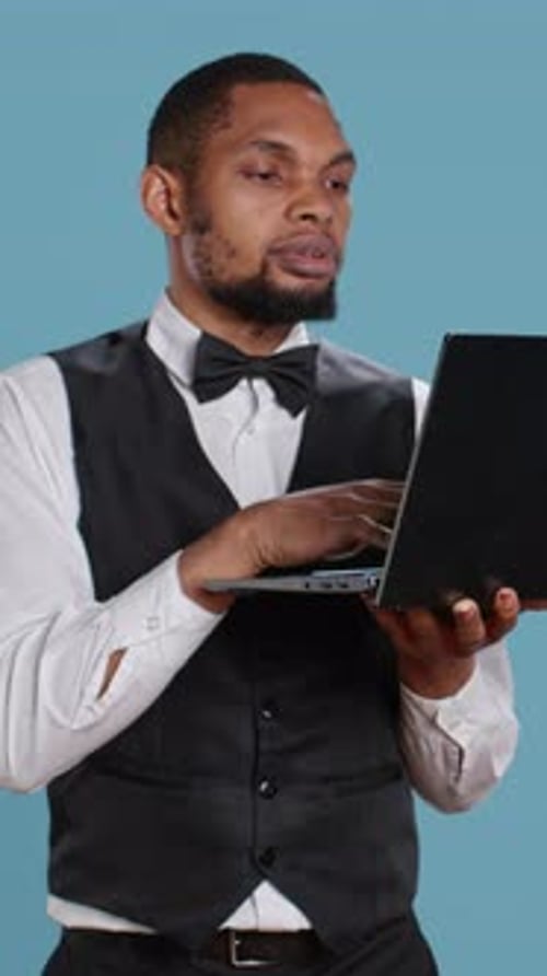 Man Interacting with Laptop in Vertical Format