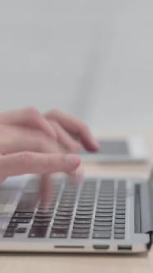 Side View of Male Hands Typing on Laptop, vertical video