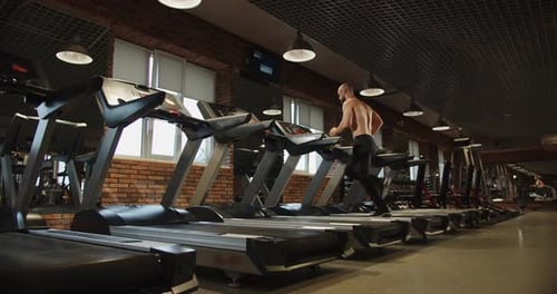 Athlete is Improving His Body Doing Cardio on a Treadmill in the Gym