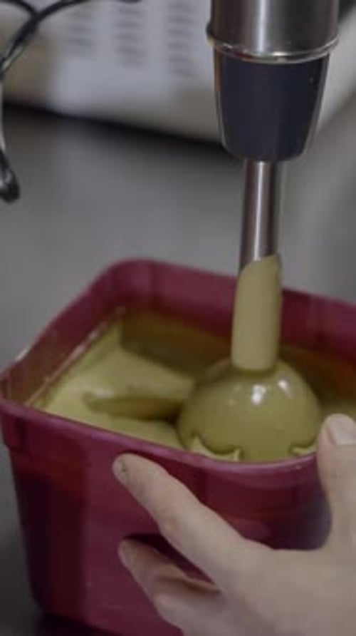 Handheld Immersion Blender Mixing Yellow Liquid