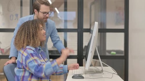 Teamwork in the Office: Man and Woman Collaborating