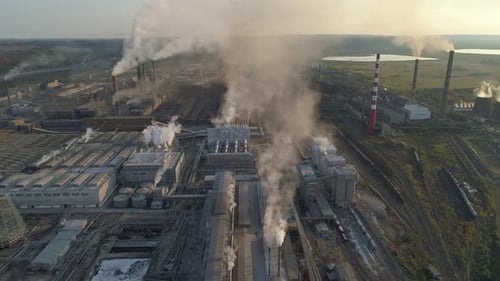 Aerial Panoramic View of an Industrial Zone with a Large Factory Many Pipes Pouring White Smoke