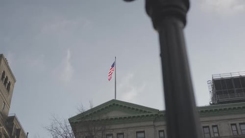 American Flag Waving on Building on a Clear Day