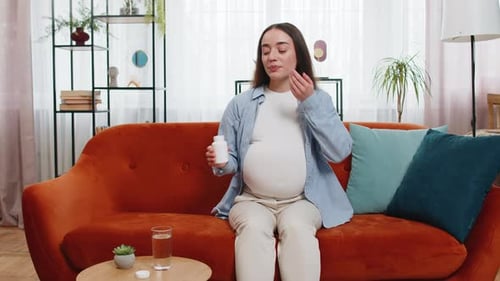Pregnant Woman Takes Prenatal Vitamins at Home