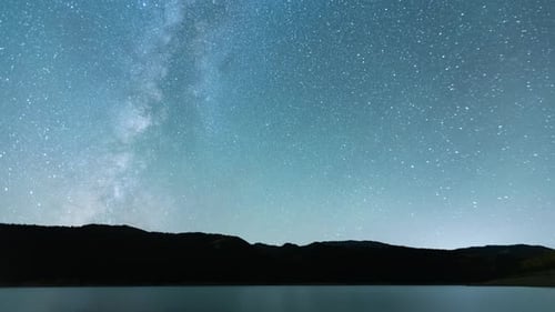 Time Lapse - Milky Way Galaxy Over the Mountains with Water in the front