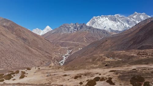 Towering Majestic Mount Everest Rising Above Rugged Nepalese Landscape Snow Dusted Peaks Stretching