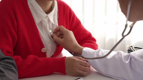 Doctor with stethoscope to check patients's pulse or body in hospital. Rigid.