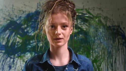 Portrait A Young Talented Artist with Dreadlocks and Red Hair in an Art Studio Looking Into the