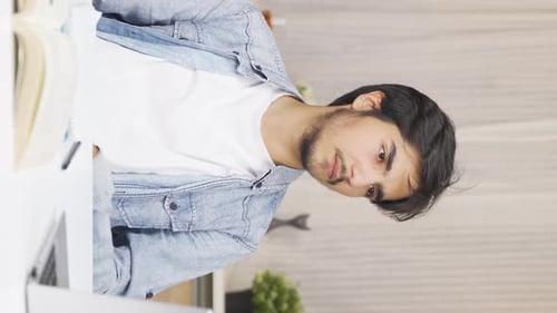 Young Adult Studying at Desk with Laptop and Book