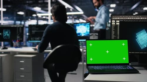 Data Center Engineer Working on Neural Network on Chroma Key Laptop
