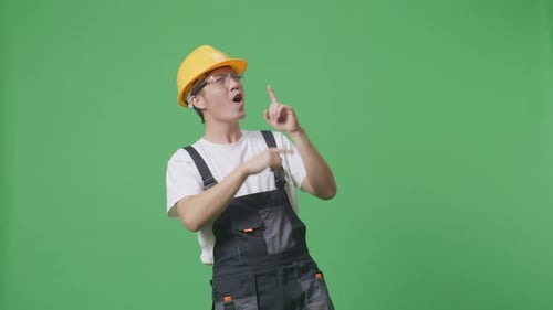 Asian Man Worker Wearing Goggles And Safety Helmet Singing And Dancing On Green Screen