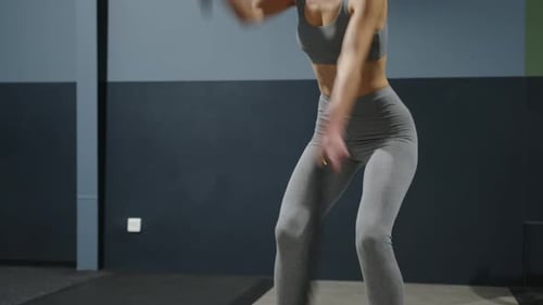 Athletic Beautiful Woman in the Gym Doing Sports Motivational Exercises to Keep Body and Mind