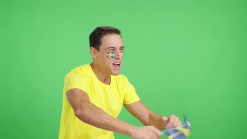 Enthusiastic Adult Fan Cheering and Waving Flag