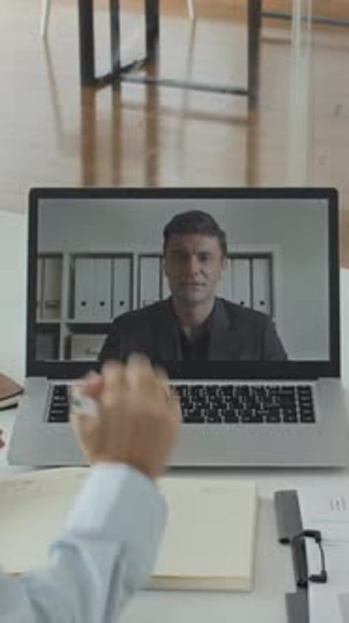 Employees Talking to Investor on Video Using Laptop at Office