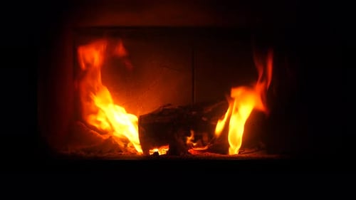 Burning Fireplace Provides Cozy Warmth in Dark Room