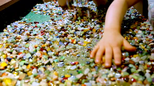 Kids rummage through wide selection of colorful gemstones with their ...