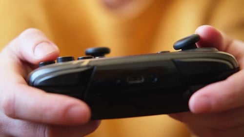 Close Up of Person Playing Video Game Controller