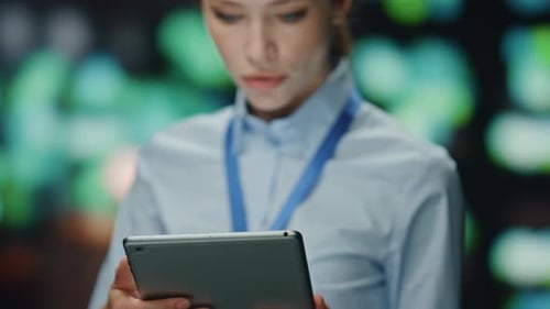 Woman Uses Tablet in Technology Setting