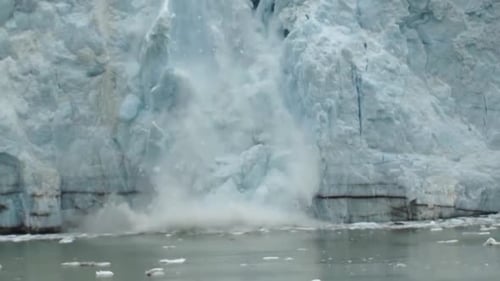Ice calving from the glacier in Alaska due to climate change. Ice melting in Alaska, Margerie glacie