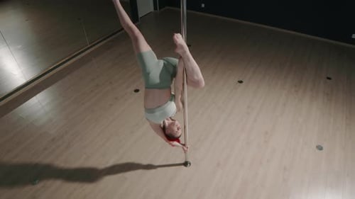 Graceful Woman Pole Dancing in Studio