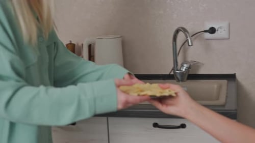 Two Friends Preparing a Snack in a Kitchen