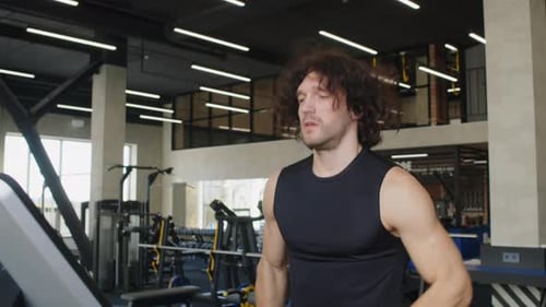 Sportsman Running on Treadmill in Fitness Club