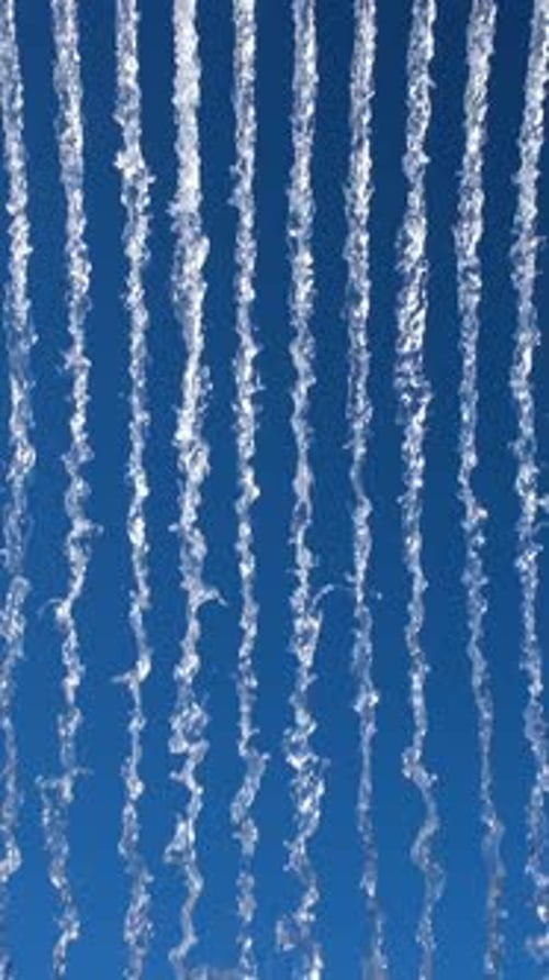 Vibrant Display of Water Streams Against a Bright Blue Sky Creating a Dynamic Abstract Pattern Ideal