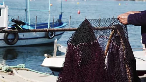Fishermen Mending Their Torn Fishing Net