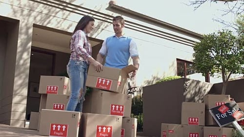 Couple Unpacking Boxes at Their New Home