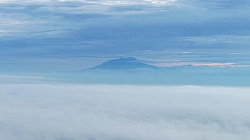 Aerial view of a mountain above clouds, indonesia.