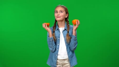 Girl Holding Halved Orange Fruit On Green Screen