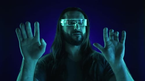Man Wearing Futuristic Eyeglasses Gesturing with Hands