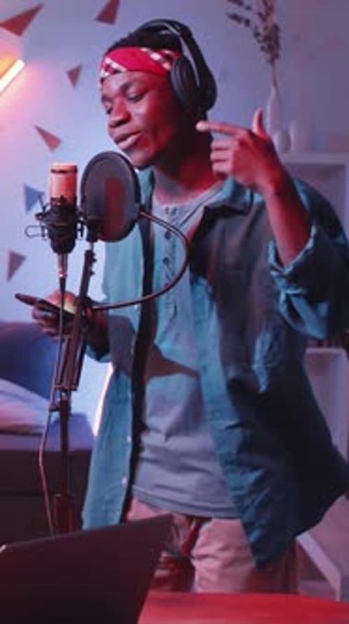 African American Singer Rapping into Microphone in Home Recording Studio