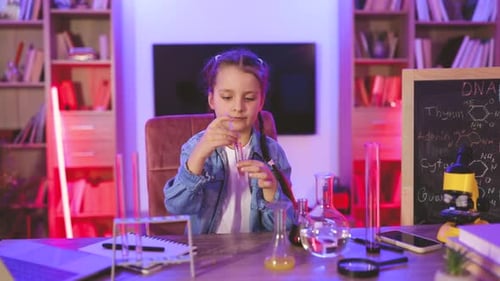 Girl Performs Science Experiment in Home Laboratory