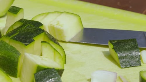 Diced Zucchini on a Yellow Cutting Board
