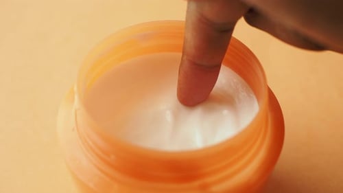 Close Up of Sunscreen Cream in a Pink Container