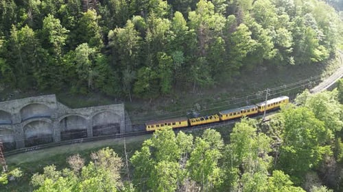 Aerial view of the yellow train near tunnels, France.