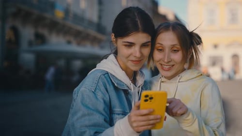 Lesbian Couple Standing in the City Centre Choosing the Pictures Scrolling Social Media Feeling