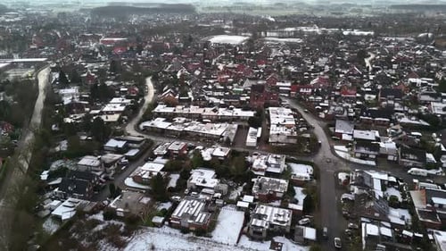Small snowy American town during frosty and icy winter day. American neighborhood with snow-covered