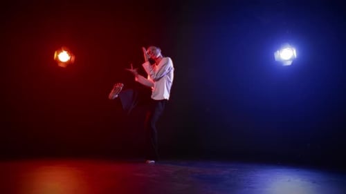 Female Dancer Performs in Red and Blue Spotlight