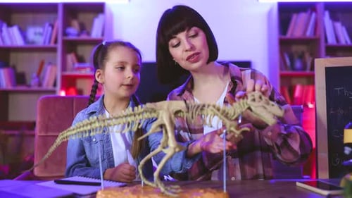 Woman Explaining Dinosaur Skeleton to Child at Home