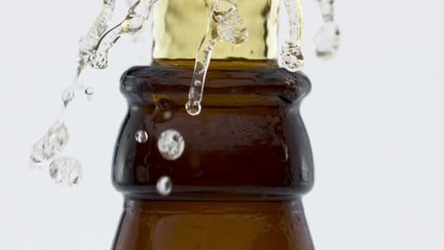 Fresh Lager Beer Fontaining From Brown Glass Bottle in Super